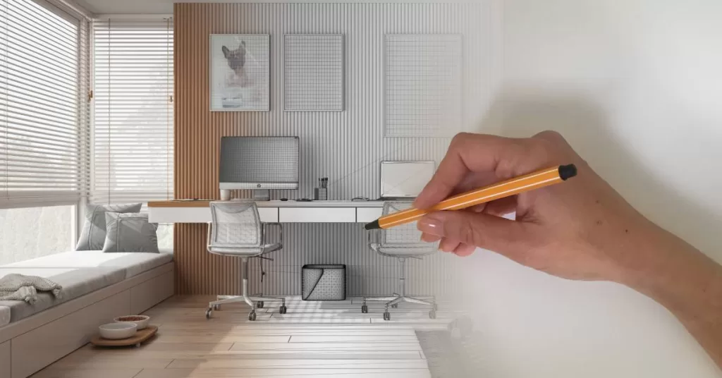 A hand holding a pen draws an illustration of a home office. An image of a home office fades from left to right into a blank page.